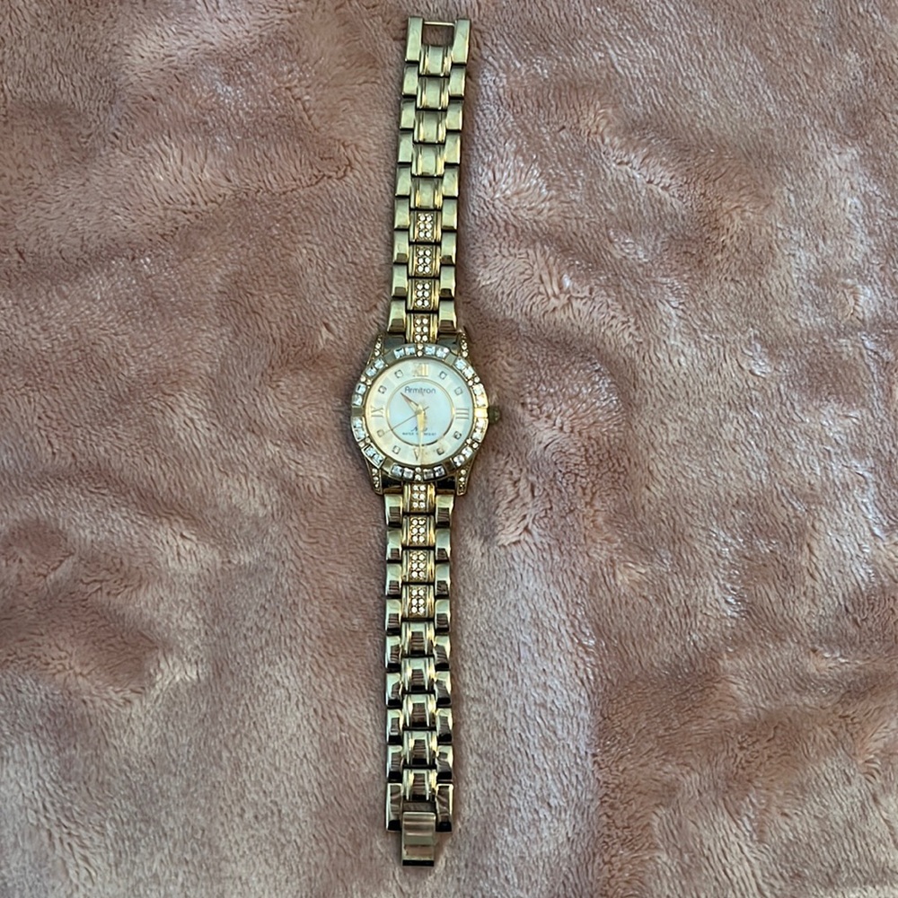 Watch, gold toned, mother of pearl face with cubic accents